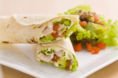 Two avocado wrap with a healthy side salad clipart