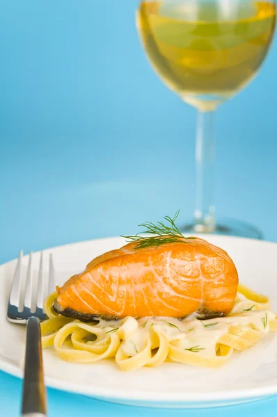 Salmon steak on pasta, decorated with dill — Stock Photo, Image