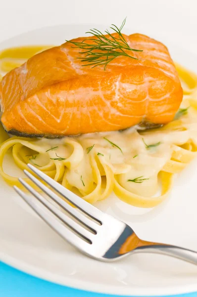 Salmon steak on pasta, decorated with dill — Stock Photo, Image