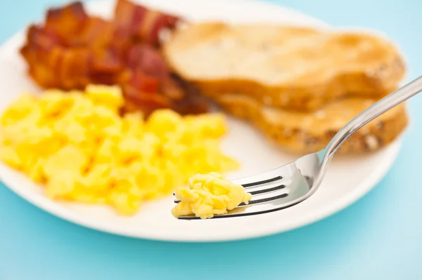 stock image American breakfast, bacon and scrambled egg blurry