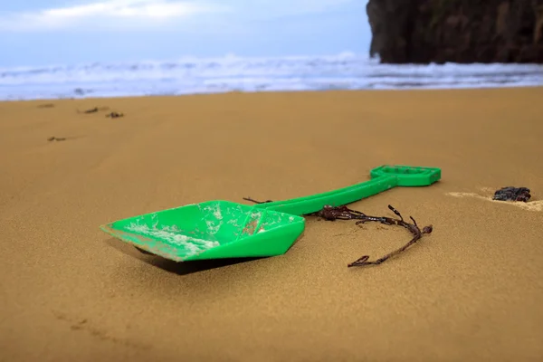 Зеленая лопата на пляже — стоковое фото