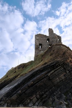 Castle ruin on a high layered cliff clipart