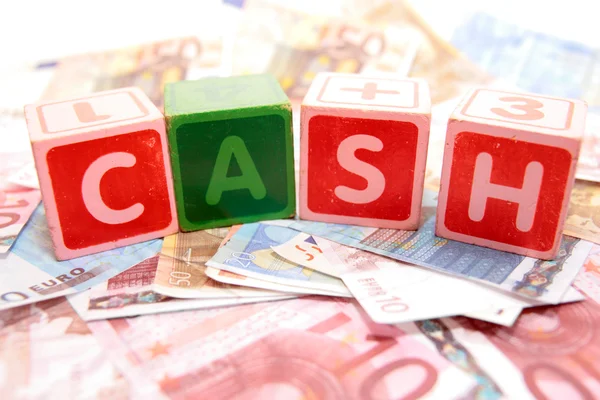 Cash in toy play block letters — Stock Photo, Image