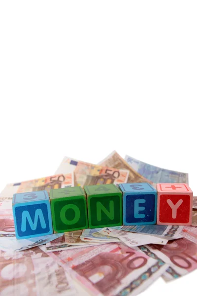 Euro money in toy play block letters — Stock Photo, Image