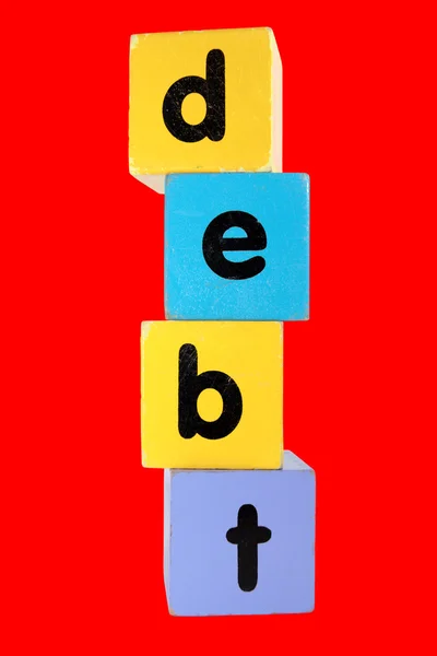 Dívida vermelha no brinquedo jogar letras de bloco com caminho de recorte — Fotografia de Stock