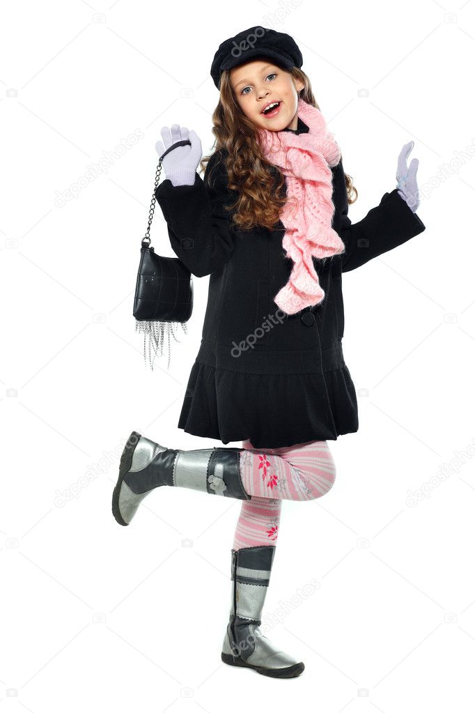 A little beautiful girl is in autumn clothes, isolated on a white backgroun