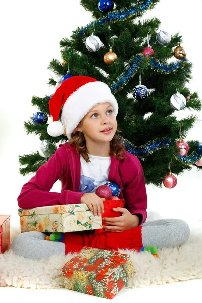 Όμορφο κοριτσάκι κοντά ένα χριστουγεννιάτικο δέντρο που απομονώνονται σε λευκό φόντο — Φωτογραφία Αρχείου