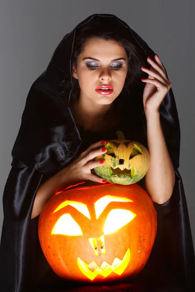 Sexual brunette in the suit of witch in night of Halloween Stock Photo