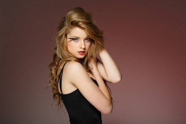 A beautiful young woman is in dark clothes