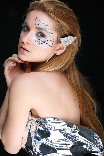 Portrait of sexual beautiful girl with strasses on face, on a black backgro