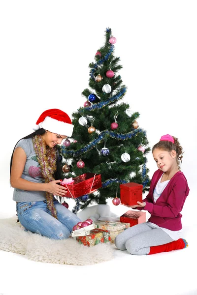 어머니와 딸 근처 흰색 b에 고립 된 선물 크리스마스 트리 — 스톡 사진