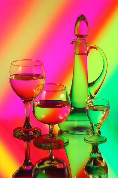 A glass jug and three wineglasses — Stock Photo, Image