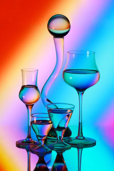 Four wineglasses, a glass ball and a vase — Stock Photo, Image