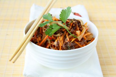 Asian style salad with carrots, meat and chili peppers clipart