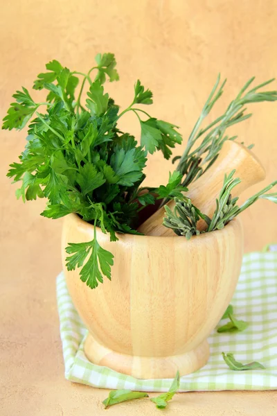 Herbs in wooden mortar with pestle — Stock Photo, Image