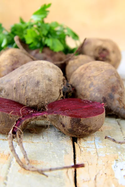 stock image Fresh organic beets with green leaves on the table