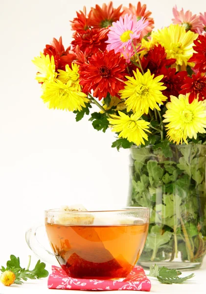 Still life with flowers and cup tea — Stock Photo, Image