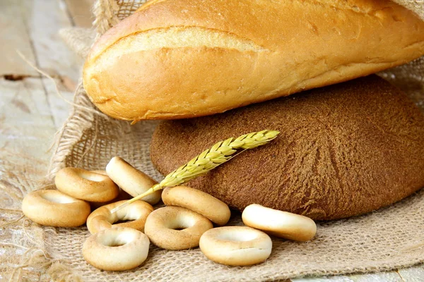 stock image Assortment of baked bread on wood table