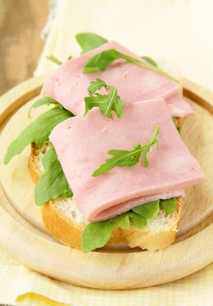 Delicious sandwich with ham on wooden table — Stock Photo, Image