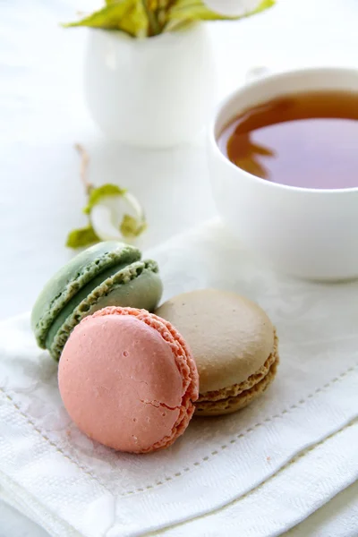 Traditional french macarons with tea set on the background — Stock Photo, Image