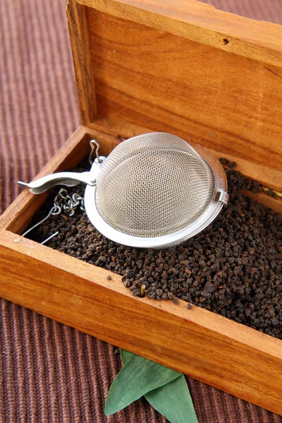 Tea strainer with a fragrant black tea — Stock Photo, Image