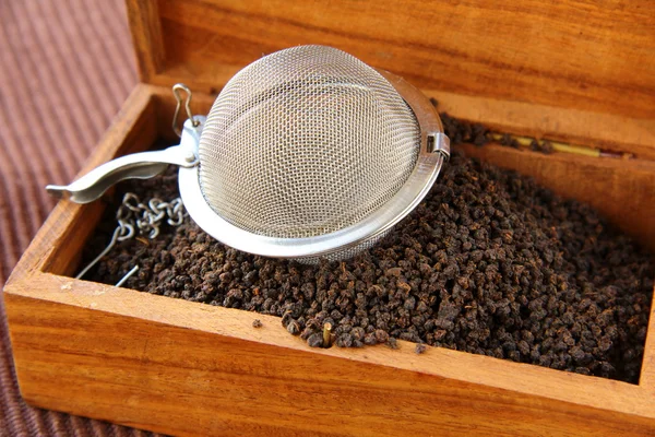 stock image Tea strainer with a fragrant black tea