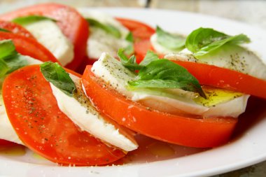 Traditional Italian Caprice salad tomato mozzarella cheese and basil clipart