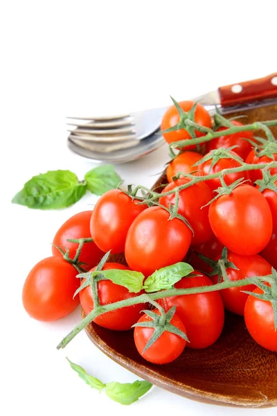 Fresh cherry tomatoes on plate, spoon and fork — Stock Photo, Image