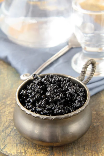 Black caviar and vodka on a white background — Stock Photo, Image
