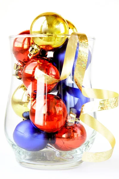 Glass filled with colorful holiday ornaments and christmas decoration over — Stock Photo, Image