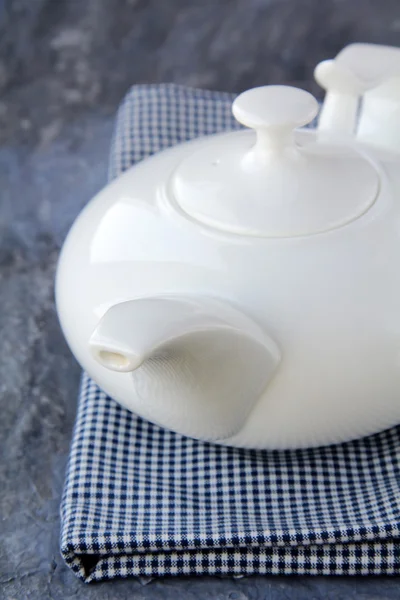Little white tea kettle on grey background — Stock Photo, Image