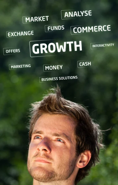 Young persons head looking at business icons and images — Stock Photo, Image