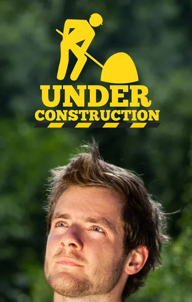 Young head looking at construction icons — Stock Photo, Image