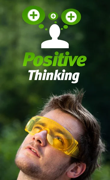 Young head looking at positive negative signs — Stock Photo, Image
