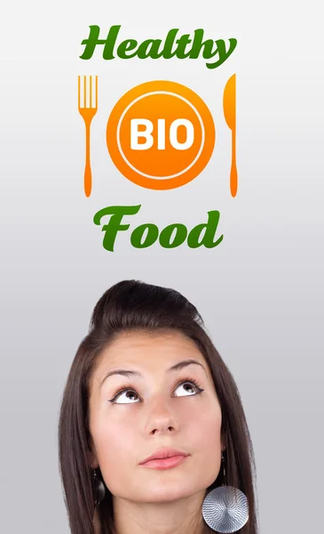 Mladá dívka na znamení zdravé potraviny — Stock fotografie