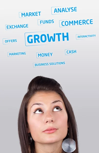 Young girl head looking at business icons and images — Stock Photo, Image