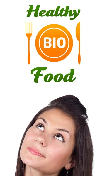 Ung flicka tittar på hälsosam mat tecken — Stockfoto
