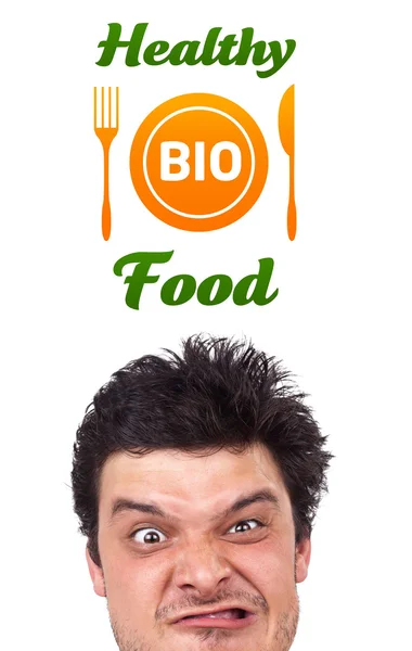 Young head looking at healthy food sign — Stock Photo, Image