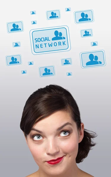 Young girl looking at social type of icons and signs — Stock Photo, Image
