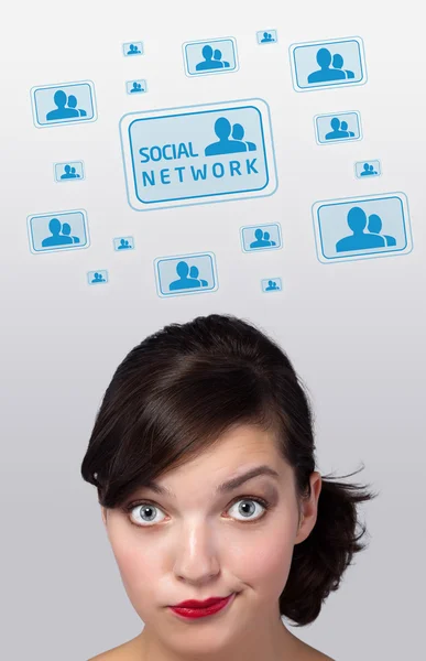 Young girl looking at social type of icons and signs — Stock Photo, Image