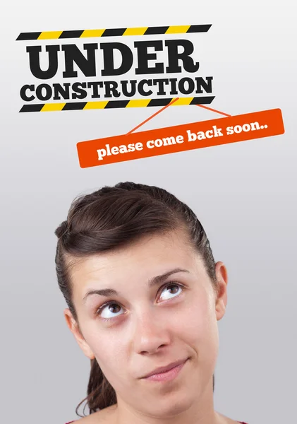 Young girl looking at contruction icons — Stock Photo, Image
