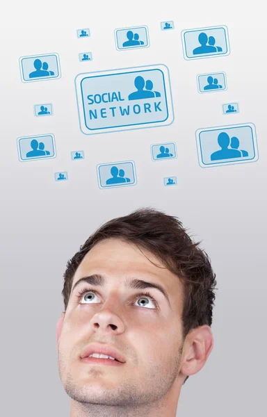 Young head looking at social type of icons and signs — Stock Photo, Image