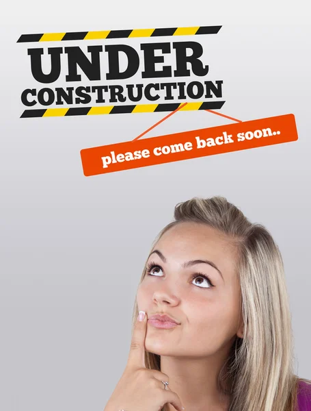 Young girl looking at contruction icons — Stock Photo, Image