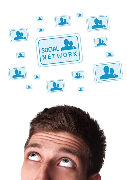 Young head looking at social type of icons and signs — Stock Photo, Image