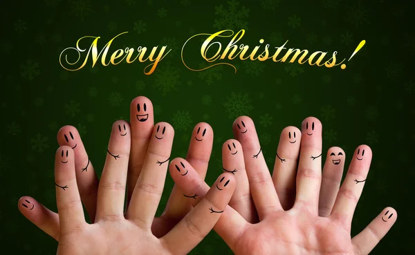 Merry christmas happy finger group with smiley faces on green ba — Stock Photo, Image