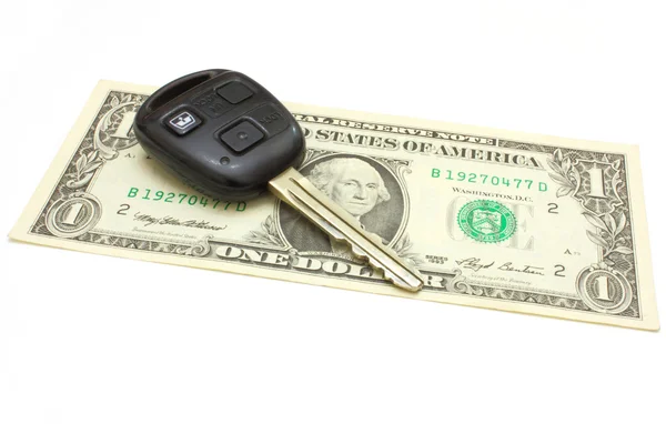 The car key lies on a dollar — Stock Photo, Image