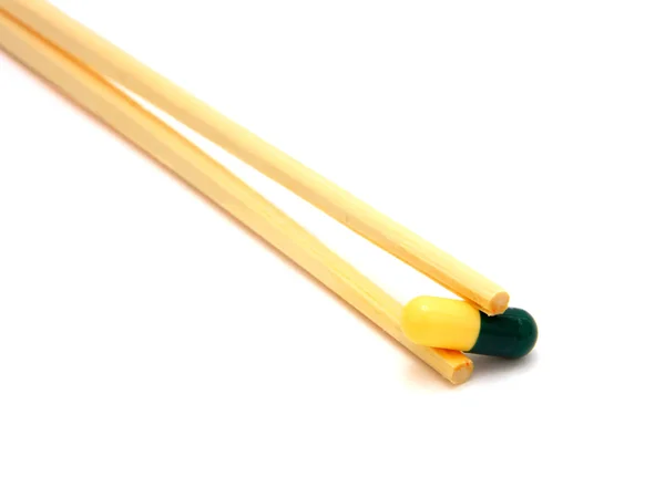 Sushi tablet on chopstick — Stock Photo, Image