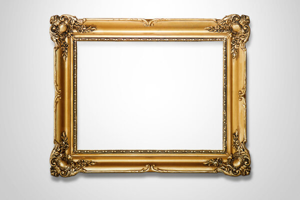 Grunge gold wooden frame on the white wall