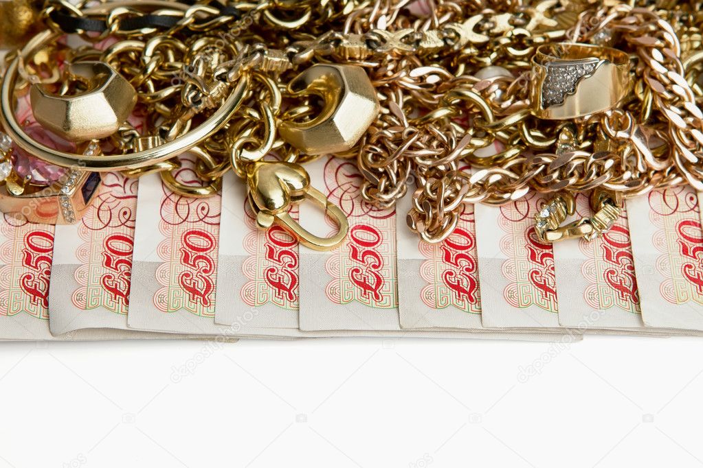 Savings, stack of golden jewellery on British Pounds
