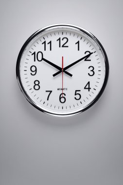 Clock hanging on the wall clipart